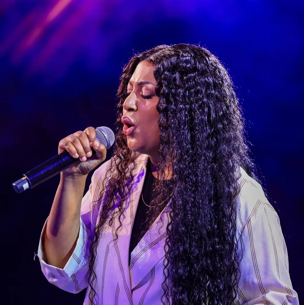 Bella Kombo leading worship at In Christ Now, Camp Kigali, July 2026